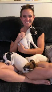 Ivy Graham with puppies